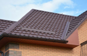 Lightweight metal roof tiles with rain gutter.