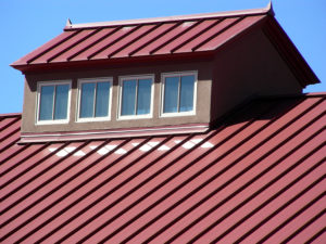Picture of a home with a red metal roof.