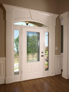 A luxurious white front entry door with a beautiful glass windows.