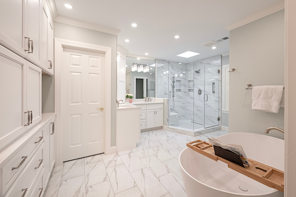 Luxury bathroom remodel in Lexington, KY featuring a custom tile shower, quartz countertops, and modern lighting.