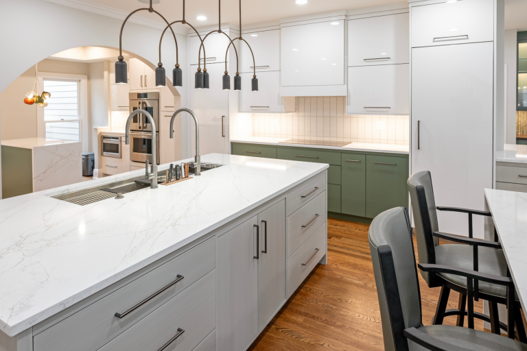 Bright, modern kitchen in Lexington KY featuring quartzite countertops, custom cabinetry, and contemporary lighting as part of a whole home remodel by BACK Construction
