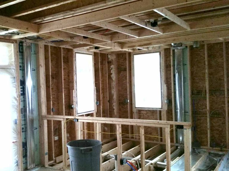 BACK Construction professionals reviewing architectural drawings and residential floor plans
